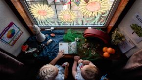 CJPOTY July 2023 shortlisted image for the Summer theme - sunflower window painting and children