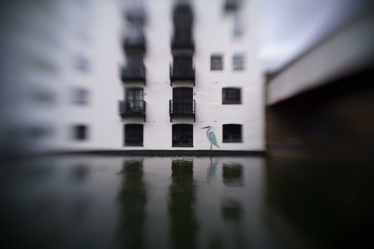 Lensbaby Sweet 22 sample image - a canalside building with a heron painted on it